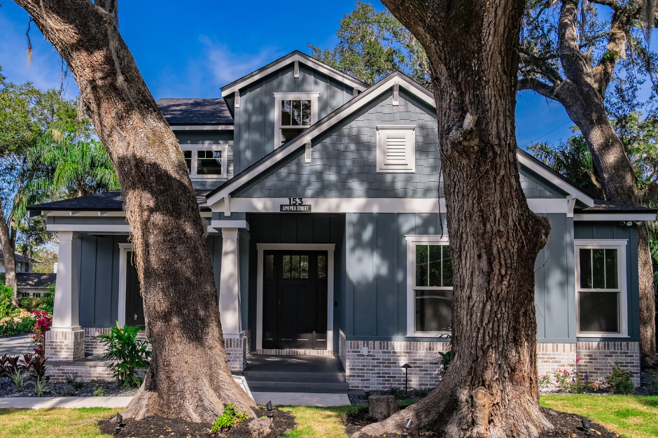 Custom home with beautiful trees in front yard.