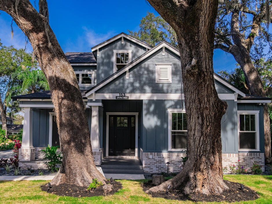 Custom home with beautiful trees in front yard.